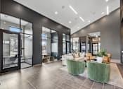 Thumbnail 13 of 20 - Modern clubhouse at Nook Nine with stylish lounge seating, private workspaces, and high ceilings.
