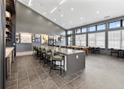 Thumbnail 11 of 20 - Stylish clubhouse at Nook Nine with modern seating, high ceilings, and vibrant artwork.