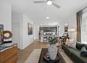 Thumbnail 2 of 20 - Open-concept living at Nook Nine with a stylish living room, modern kitchen, and wood-style flooring.
