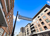 Thumbnail 56 of 68 - a street sign for monon blvd between two buildings at Gramercy Apartments, Carmel, IN 46032