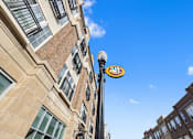 Thumbnail 64 of 68 - a sign on a pole in front of a building at Gramercy Apartments, Carmel