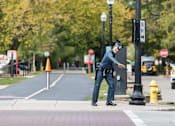 Thumbnail 65 of 68 - a police officer is standing on the curb of a street at Gramercy Apartments, Indiana, 46032