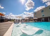 Thumbnail 34 of 36 - a swimming pool at a hotel with a blue sky at The Century at Purdue Research Park-Student, West Lafayette, IN 47906