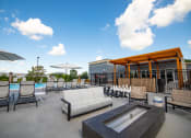 Thumbnail 31 of 36 - a patio with couches chairs and tables and a poolat The Century at Purdue Research Park-Student, West Lafayette, IN