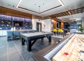 Thumbnail 16 of 36 - a game room with a pool table and a bar at The Century at Purdue Research Park-Student, Indiana, 47906