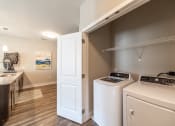 Thumbnail 10 of 36 - a washer and dryer in a laundry room with a sink and a door at The Century at Purdue Research Park-Student, Indiana