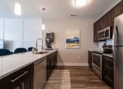 Thumbnail 6 of 36 - a kitchen with stainless steel appliances and a marble counter topat The Century at Purdue Research Park-Student, West Lafayette, IN 47906