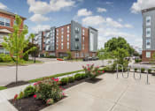 Thumbnail 3 of 34 - an exterior view of an apartment complex with a sidewalk and playground at 310 at Nulu Apartments-Student, Louisville, KY