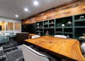 Thumbnail 6 of 34 - a conference room with a wooden table and green walls at 310 at Nulu Apartments-Student, Louisville, 40202