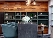 Thumbnail 7 of 34 - a dining room with green chairs and a table with white flowers at 310 at Nulu Apartments-Student, Kentucky