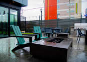 Thumbnail 16 of 34 - a patio with chairs and a fire pit at 310 at Nulu Apartments-Student, Kentucky