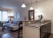Thumbnail 21 of 34 - an open kitchen and living room with a couch and a table at 310 at Nulu Apartments-Student, Louisville Kentucky
