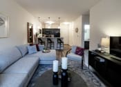 Thumbnail 23 of 34 - a living room and kitchen with a couch and a table at 310 at Nulu Apartments-Student, Louisville, 40202