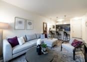 Thumbnail 25 of 34 - a living room with a couch and a table and a kitchen at 310 at Nulu Apartments-Student, Kentucky, 40202