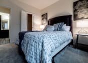Thumbnail 27 of 34 - a bedroom with a large bed and a bathroom at 310 at Nulu Apartments-Student, Louisville, KY