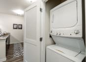 Thumbnail 29 of 34 - a washer and dryer in a laundry room with a sink and a door at 310 at Nulu Apartments-Student, Kentucky