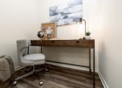 Thumbnail 30 of 34 - a desk with a chair and a painting on the wall at 310 at Nulu Apartments-Student, Louisville Kentucky
