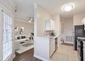 Thumbnail 1 of 33 - A modern kitchen with white cabinets and appliances at Village at Almand Creek, Conyers, 30094