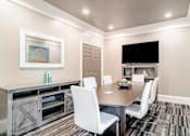 Thumbnail 27 of 33 - A modern dining room with a wooden table at Village at Almand Creek, Conyers