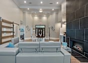 Thumbnail 30 of 33 - A modern living room with a grey sofa and a fireplace at Village at Almand Creek, Conyers, GA