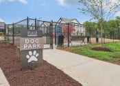 Thumbnail 37 of 38 - a dog park sign in front of a fenced in dog park