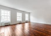 Thumbnail 13 of 18 - an empty room with hardwood floors and three windows