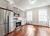 Thumbnail 11 of 18 - a kitchen with gray cabinets and white appliances