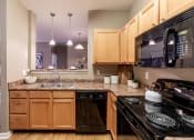 Thumbnail 16 of 32 - Modern kitchen appliances at The Reserve at Williams Glen Apartments, IN, 46077