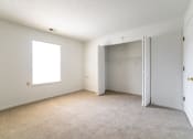 Thumbnail 20 of 37 - an empty bedroom with a closet and a window