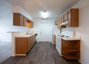 Thumbnail 31 of 37 - a kitchen with wood flooring and white appliances