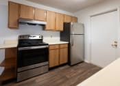 Thumbnail 30 of 37 - a kitchen with a stove and refrigerator in a 555 waverly unit