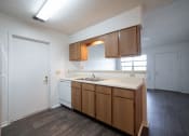 Thumbnail 19 of 37 - a kitchen with white appliances and wooden cabinets