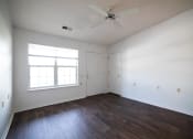 Thumbnail 33 of 37 - a bedroom with white walls and hardwood floors