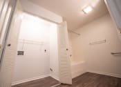 Thumbnail 18 of 37 - a bedroom with a medium sized closet and a bathtub