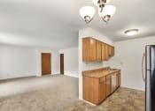 Thumbnail 3 of 25 - Open living room to kitchen layout at Somerset Apartments in Marion, IN.