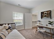 Thumbnail 40 of 65 - Bright open-concept living room with plush carpeting, large window, and patio access at Steeplechase at Shiloh Crossing Apartments in Avon, Indiana.