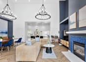 Thumbnail 59 of 65 - Spacious resident clubhouse featuring a modern fireplace, comfortable lounge seating, coworking tables, designer chandeliers, and upscale community amenities at Steeplechase at Shiloh Crossing Apartments in Avon, Indiana.