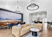 Thumbnail 63 of 65 - Spacious resident clubhouse with comfortable lounge seating, coworking tables, vaulted ceilings, designer lighting, and modern finishes at Steeplechase at Shiloh Crossing Apartments in Avon, Indiana.
