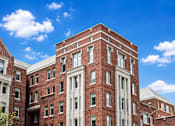 Thumbnail 8 of 58 - A red brick building with white trim and windows.