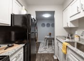 Thumbnail 1 of 38 - a kitchen with white cabinets and a black refrigerator
