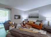 Thumbnail 4 of 38 - a living room with a couch and a chair and a tv