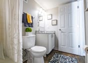 Thumbnail 24 of 38 - a bathroom with a toilet and a sink and a shower
