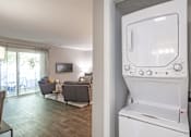 Thumbnail 27 of 38 - the living room has a washer and dryer in it and a living room
