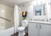 Thumbnail 23 of 38 - a bathroom with a toilet and a tub and a sink