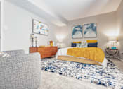 Thumbnail 22 of 38 - a living room with a bed and a couch