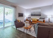 Thumbnail 5 of 38 - a living room with a sliding glass door to a patio