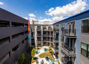 Thumbnail 25 of 53 - a view of a courtyard in a mix of apartment buildings