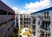 Thumbnail 22 of 53 - an aerial view of an apartment complex with a pool in the middle
