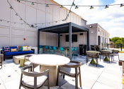 Thumbnail 53 of 53 - a patio area with tables and chairs and a television