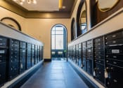 Thumbnail 52 of 53 - a row of lockers in a hallway with a large window at the end of the hallway